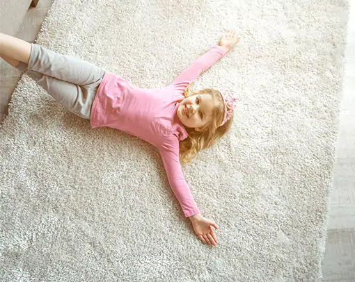 Cute girl laying on rug | De/Mar Design Studio